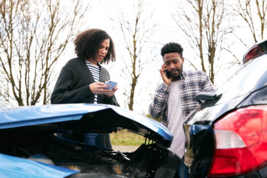 car accident victim photographing accident damage or injuries with their phone, demonstrating gathering evidence and seeking legal help from Foyle Legal