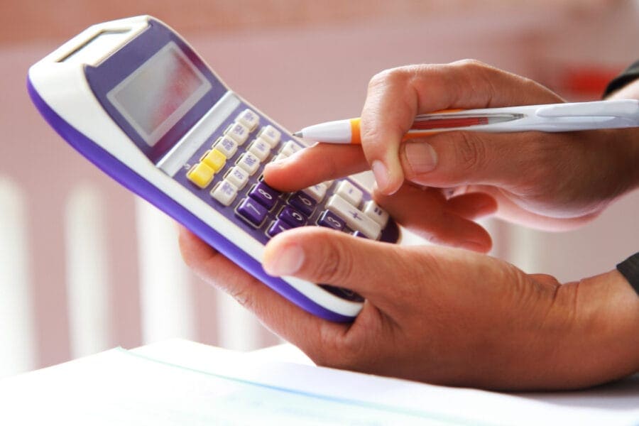 using a calculator symbolizes tallying up compensation amounts and considerations.